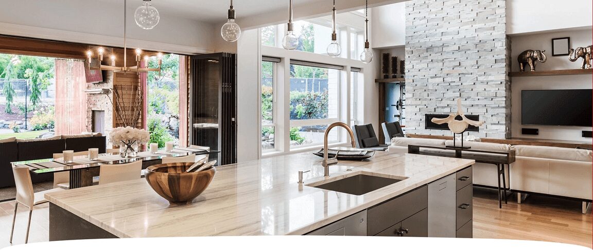 A kitchen with a sink and lots of windows.